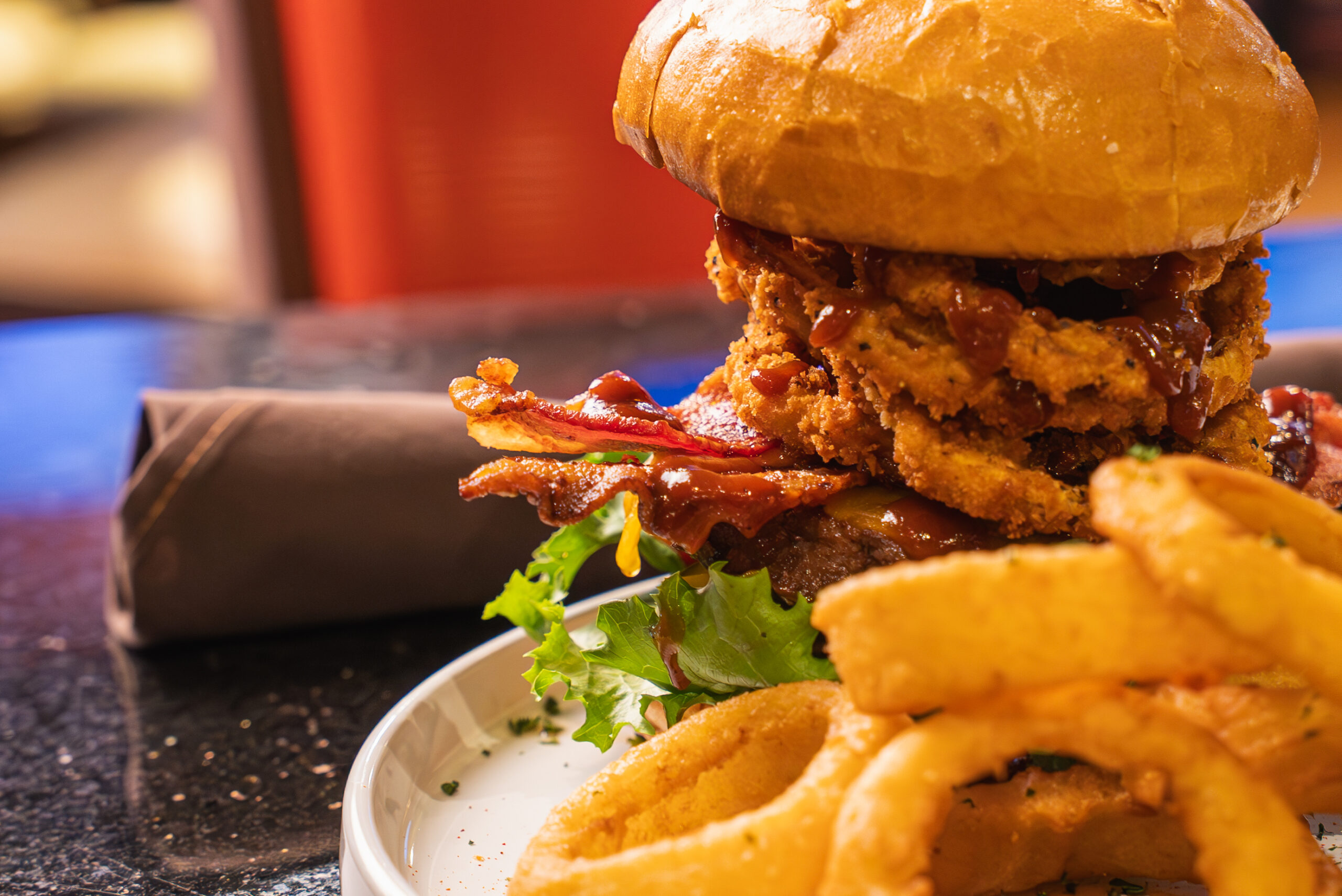 Crispy fried chicken sandwich with bacon and onion rings served at restaurant in Yreka, CA