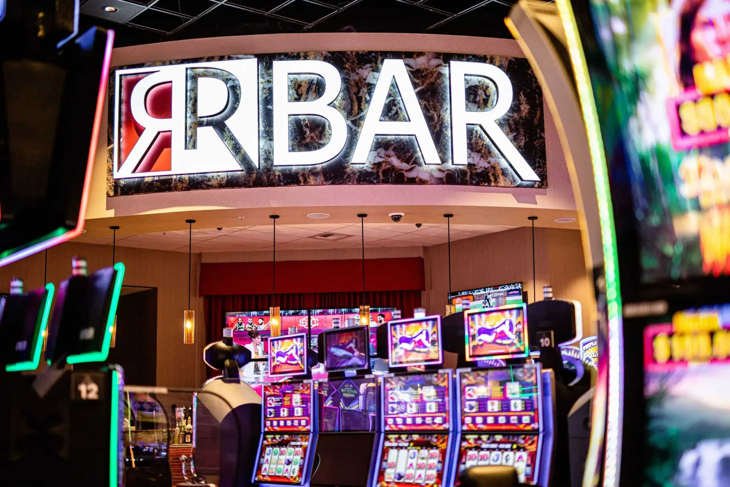 Casino with slot machines and a sign displaying 