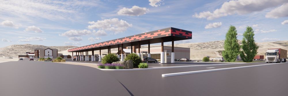 Travel plaza fueling station with covered lanes, parking areas, trucks, and desert landscape
